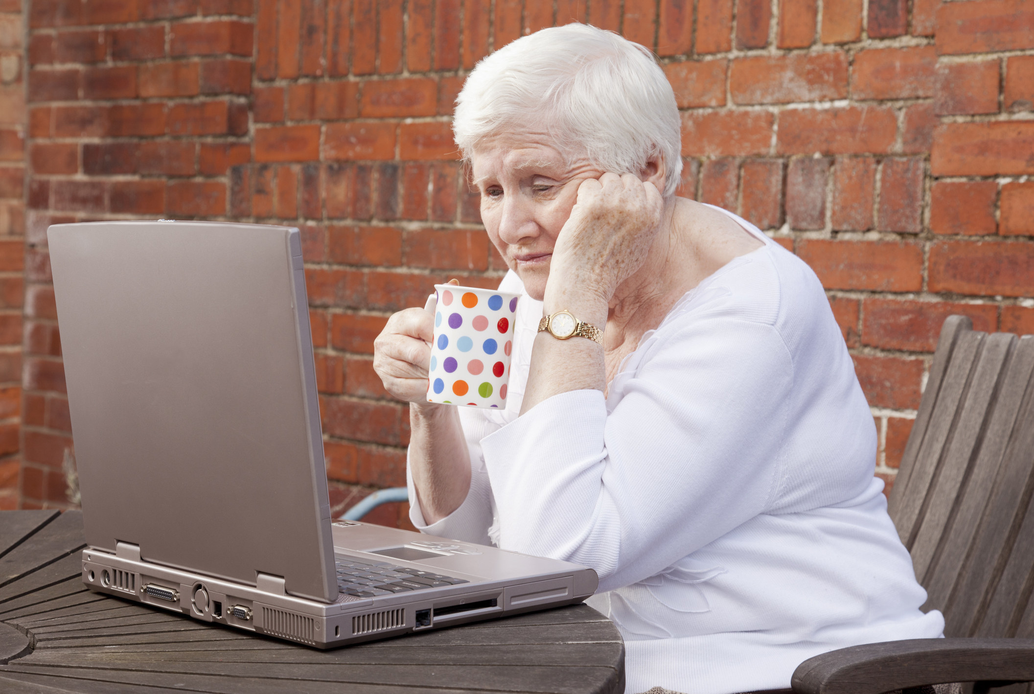 A woman looking depressed at her computer