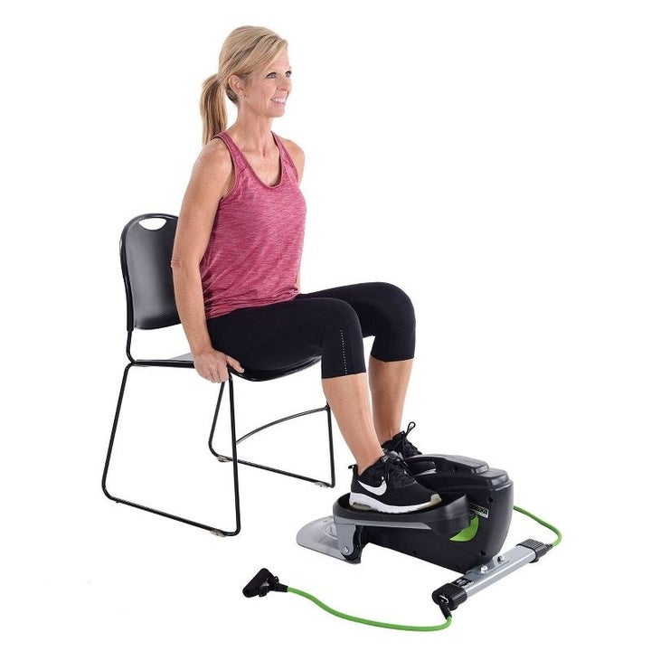 A model using the elliptical while seated in a chair