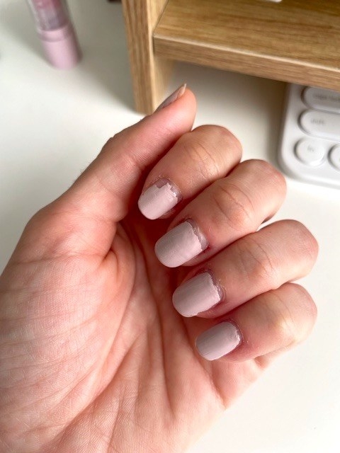 Hand with pink nail polish