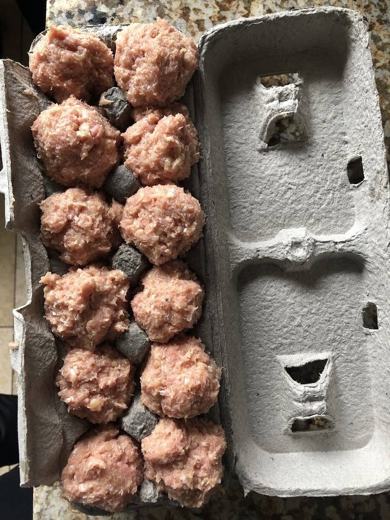 An egg carton with meatballs in it