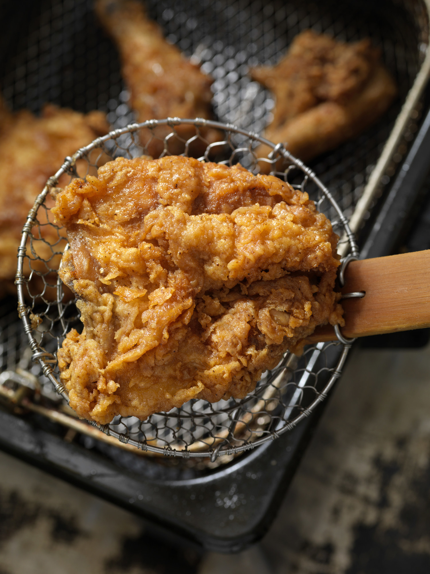 Removing fried chicken from oil