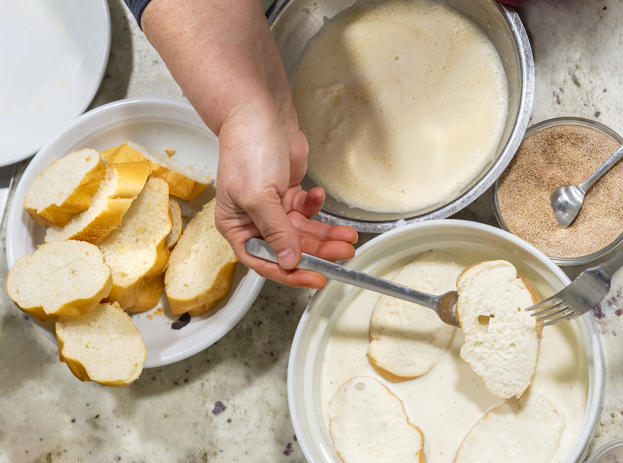 An overhead shot of a person preparing French toast