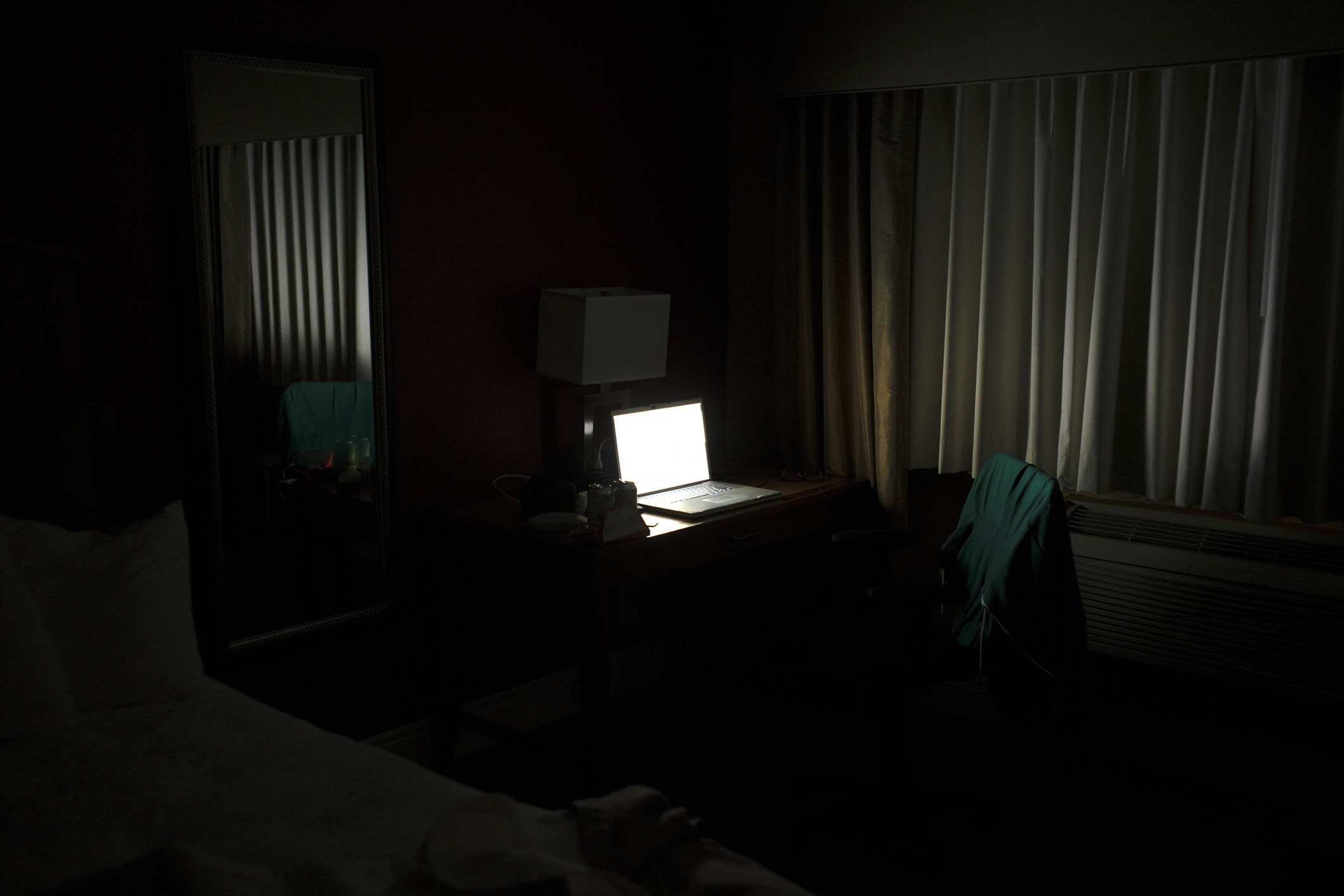 An opened laptop in a dark room