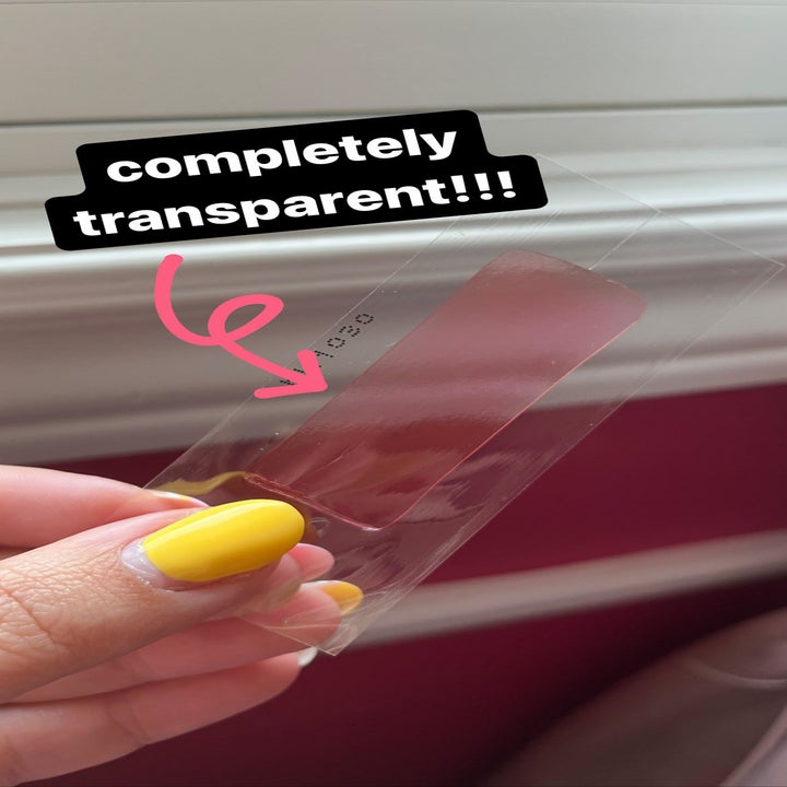 Bianca holding up the wax strip showing that it's clear