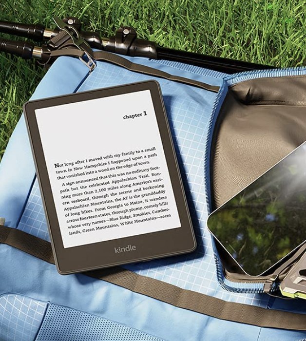 The e-reader on a bag outside near a smartphone