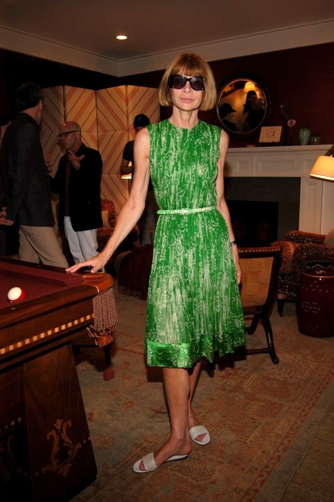 Anna Wintour standing by a pool table