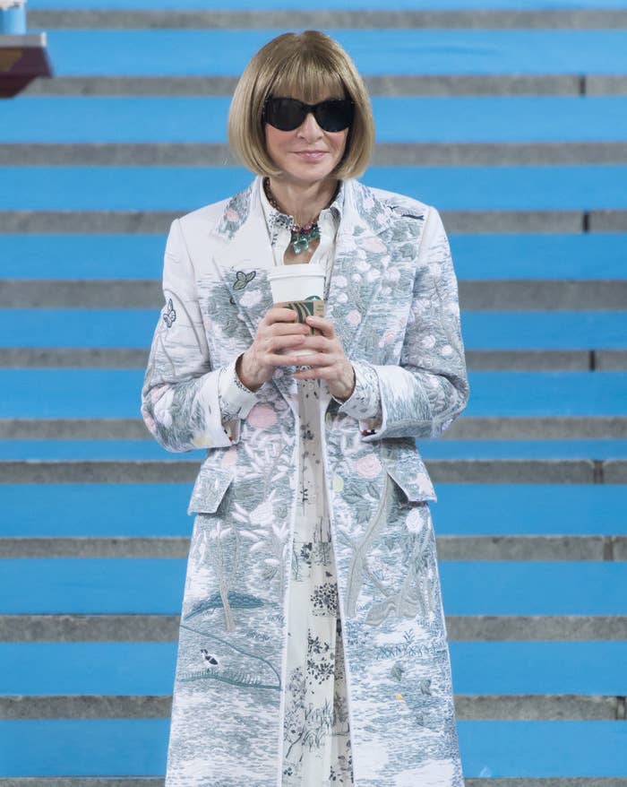 Anna Wintour holding a cup of coffee