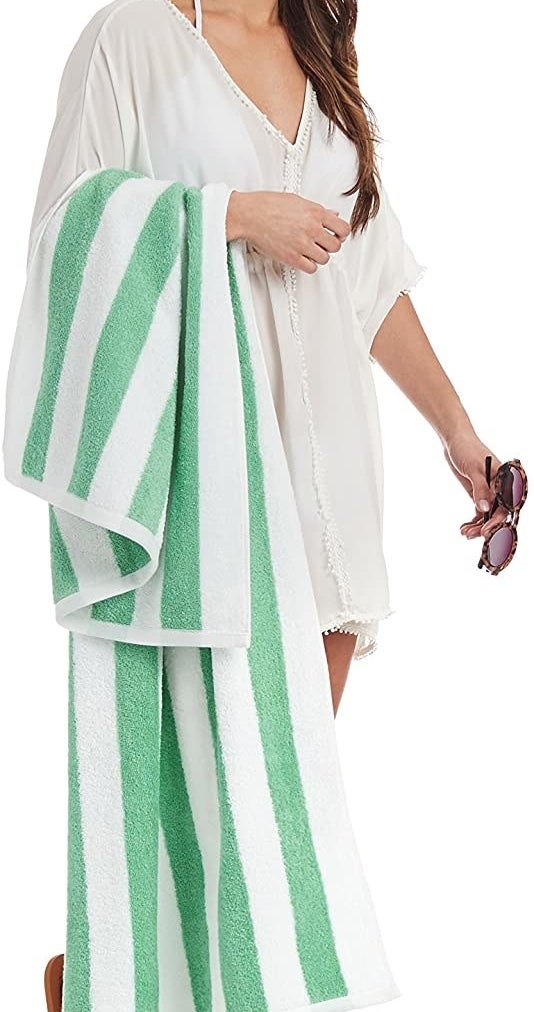 A person carrying the plush beach towel