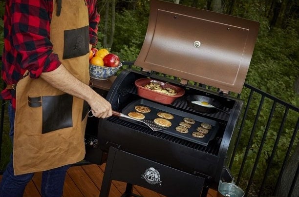 a model using the grill to cook pancakes, eggs and sausages