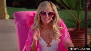 A gif of Sharpay from High School Musical waving on a lounge chair by a pool