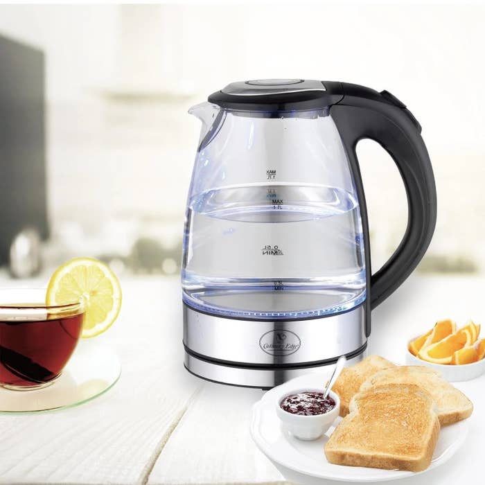 an electric tea kettle with black handle