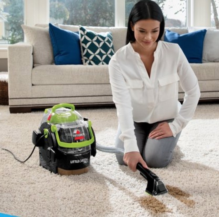 A model using a carpet cleaner
