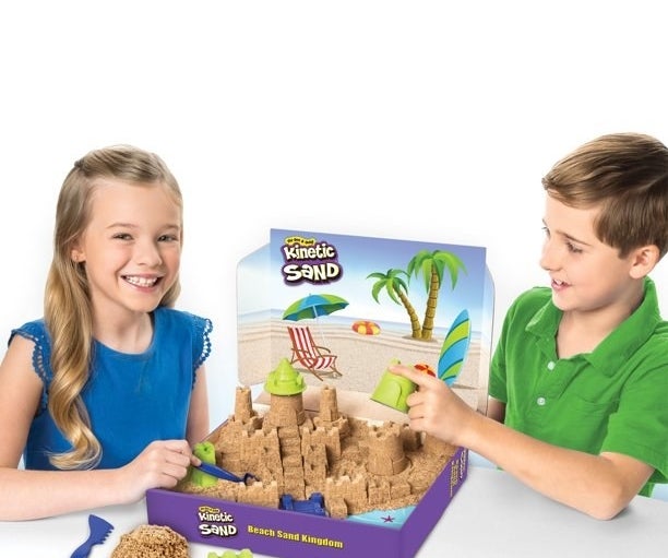 Two kids playing with kinetic sand