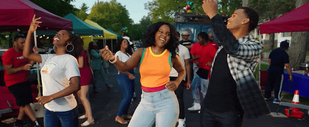 GIF of three people dancing together outside