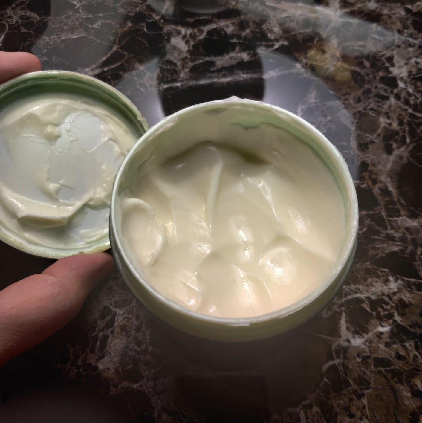 reviewer&#x27;s photo of the jar open showing thick and creamy body butter