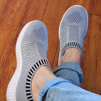 reviewer wearing the knit sneakers successful grey