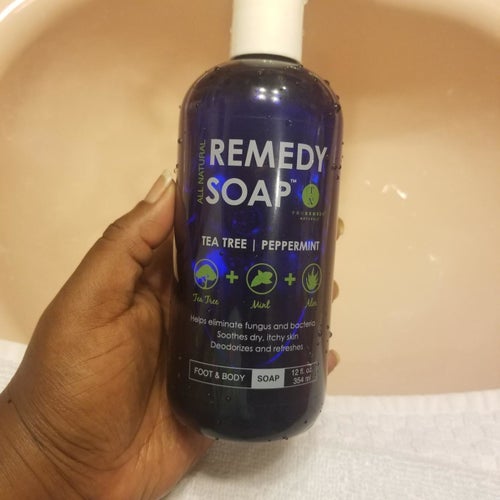 reviewer holding the bottle in their hand