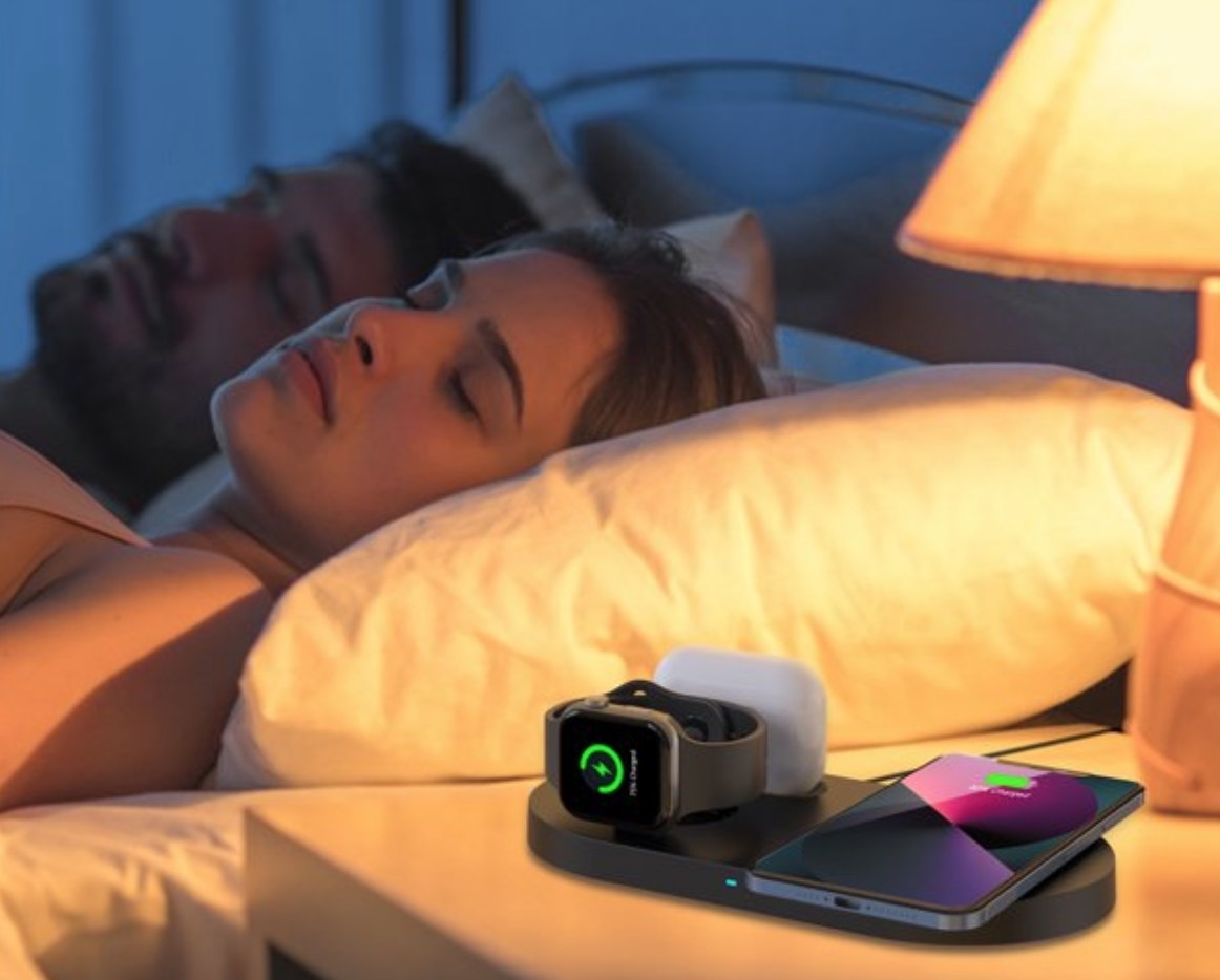 A charging station with an Apple watch, Airpods, and iPhone