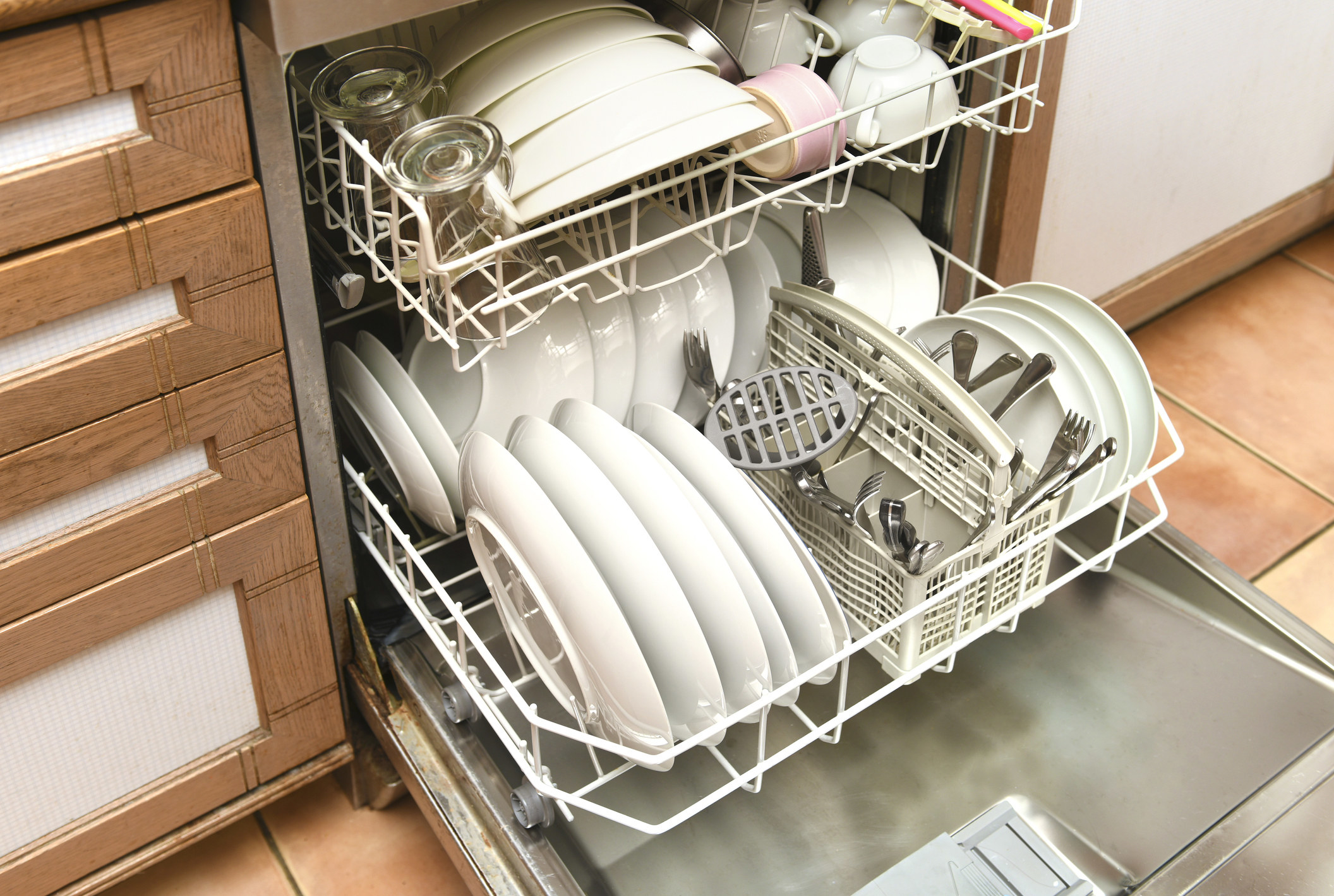 dishes being loaded in the dishwasher
