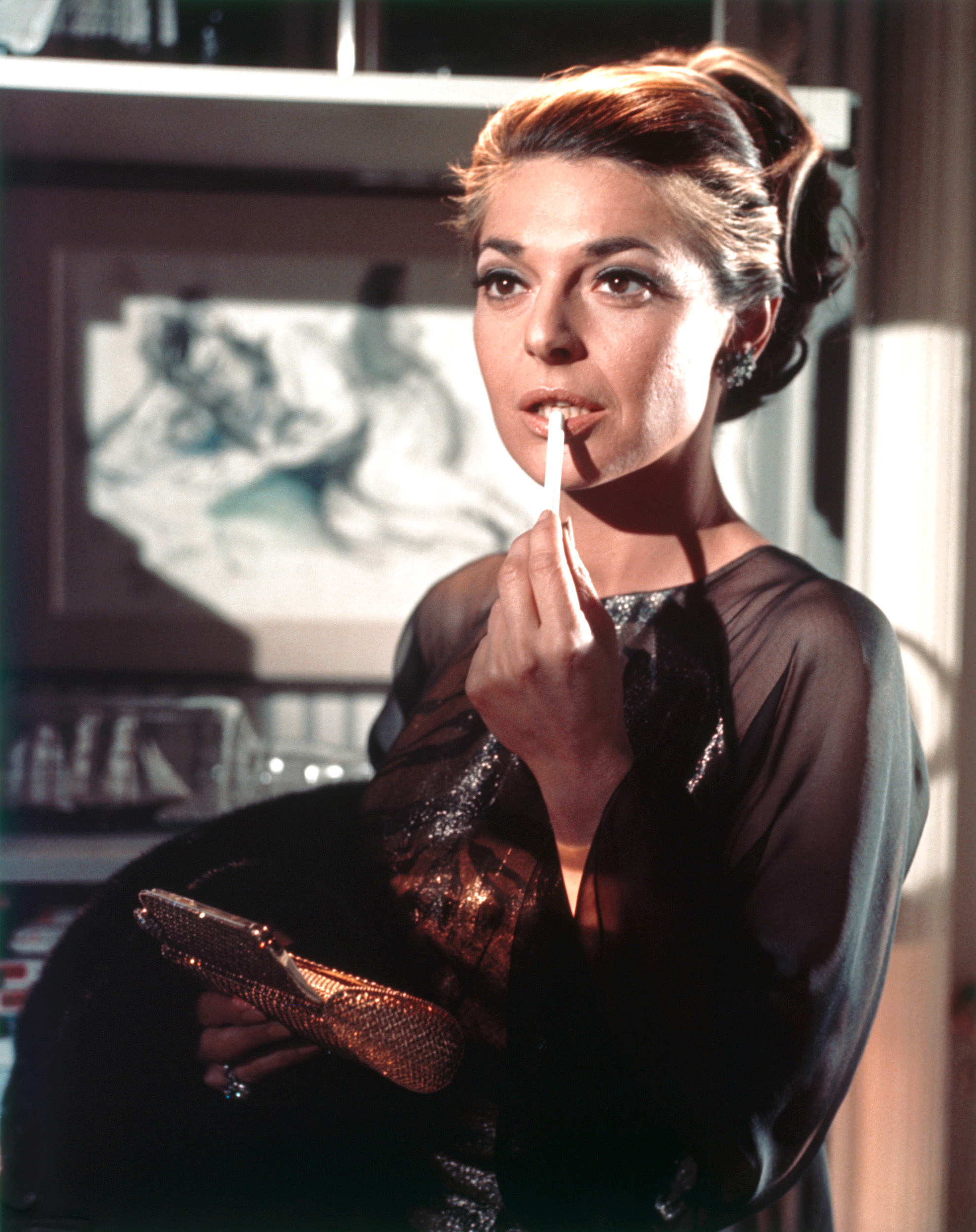 mrs. robinson holding a smoke and her clutch
