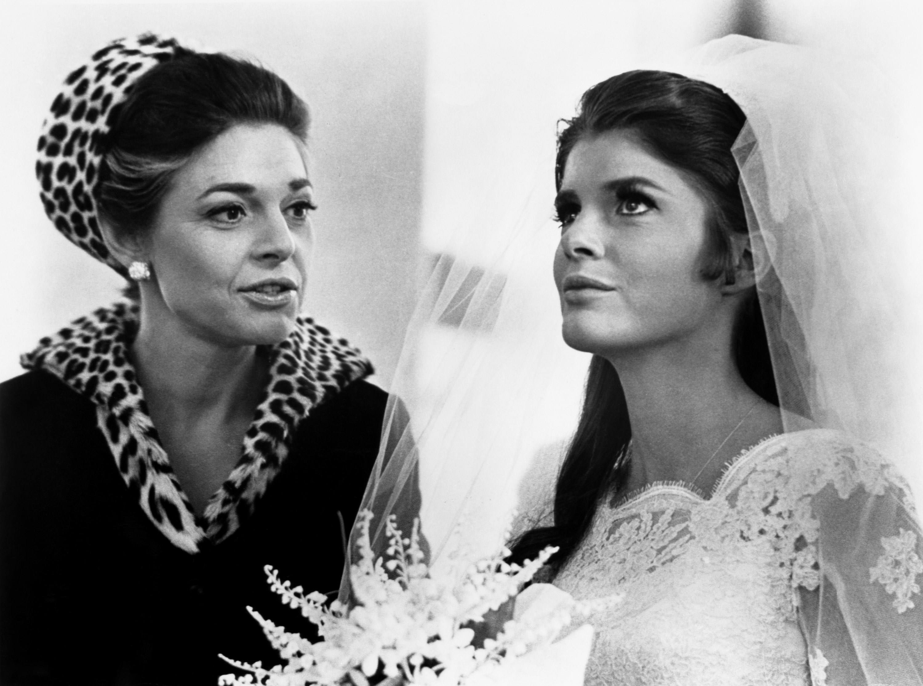 Mrs. Robinson standing by her daughter in a wedding dress