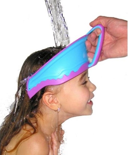 Shower cap being help to child's head