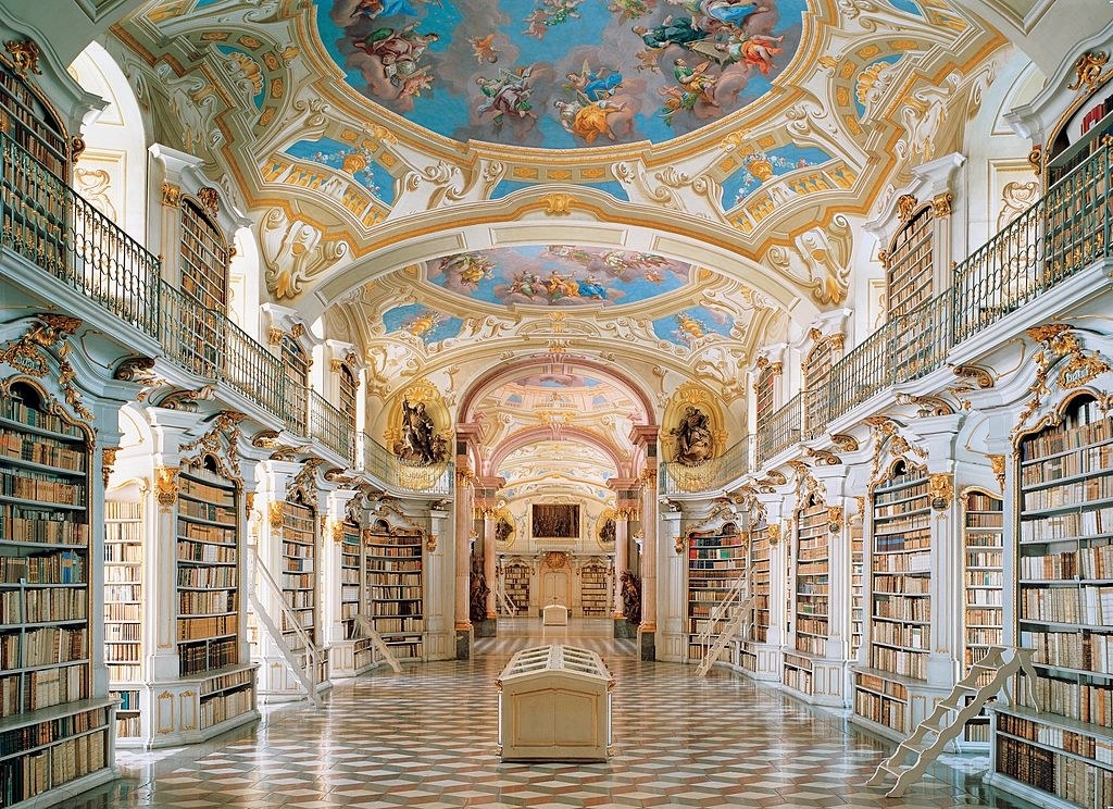 A big library with an ornate painted ceiling