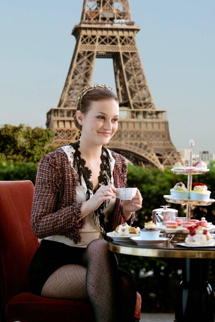 Blair Waldorf having tea at a place with the Eiffel Tower in the background