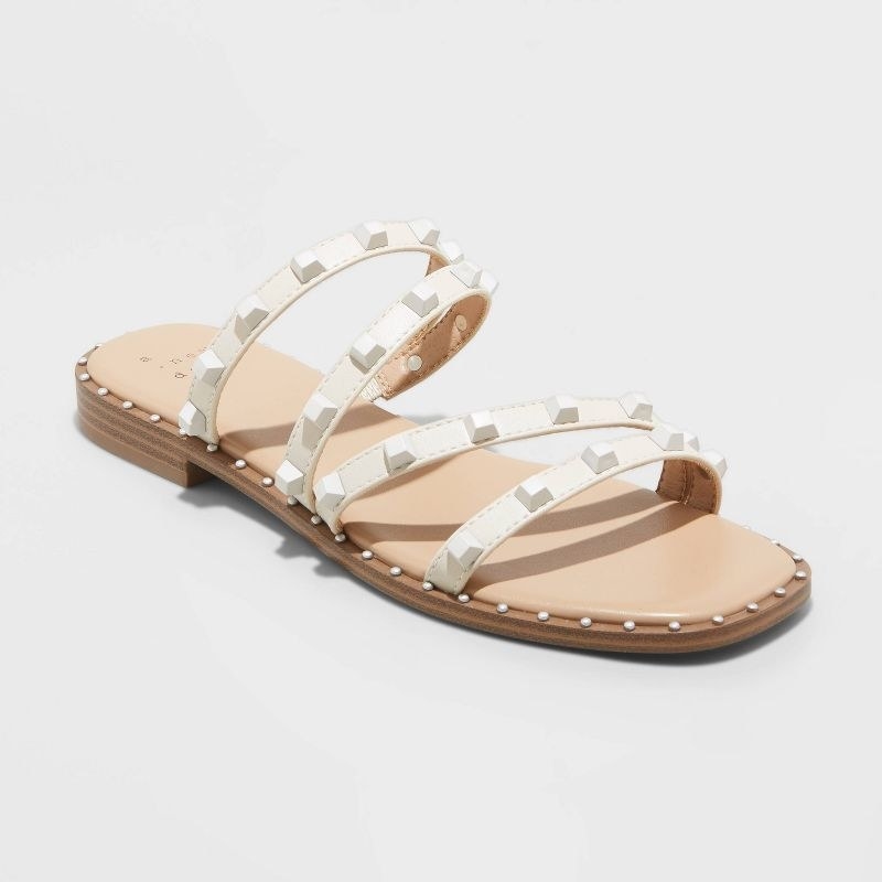 white flat strappy sandals with embellishments