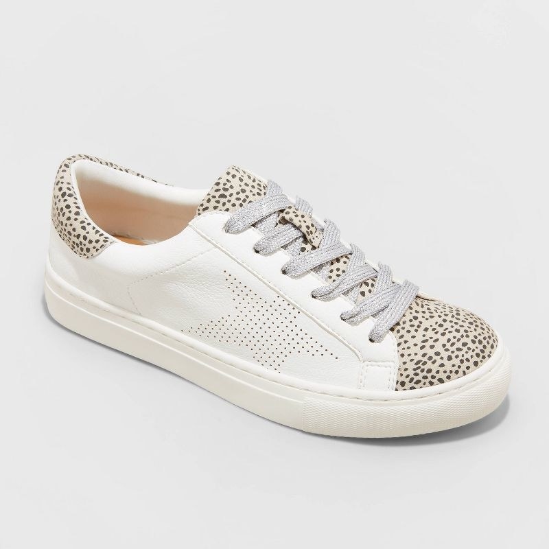 white sneakers with patterned tongue and back and perforated sides