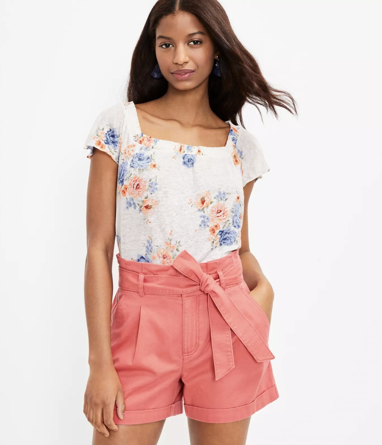 model wearing the pink tie waist shorts with white floral top