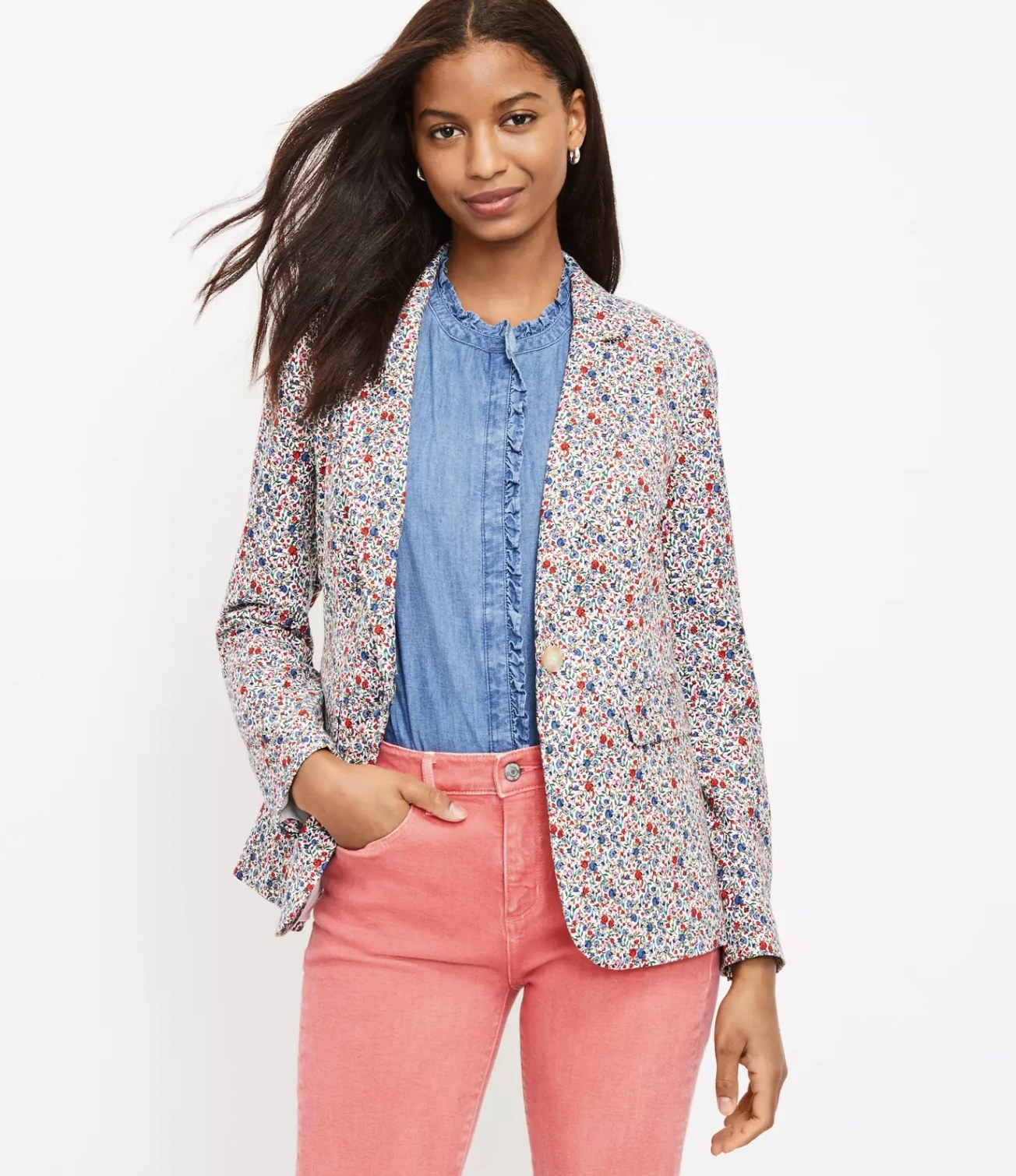 Model wearing the blazer over blue denim blouse tucked into pink coral pants