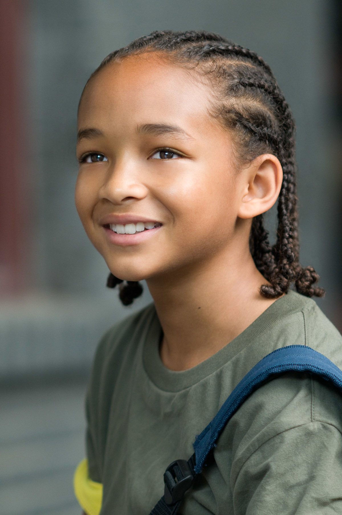 close up of Jaden with braids and a backpack
