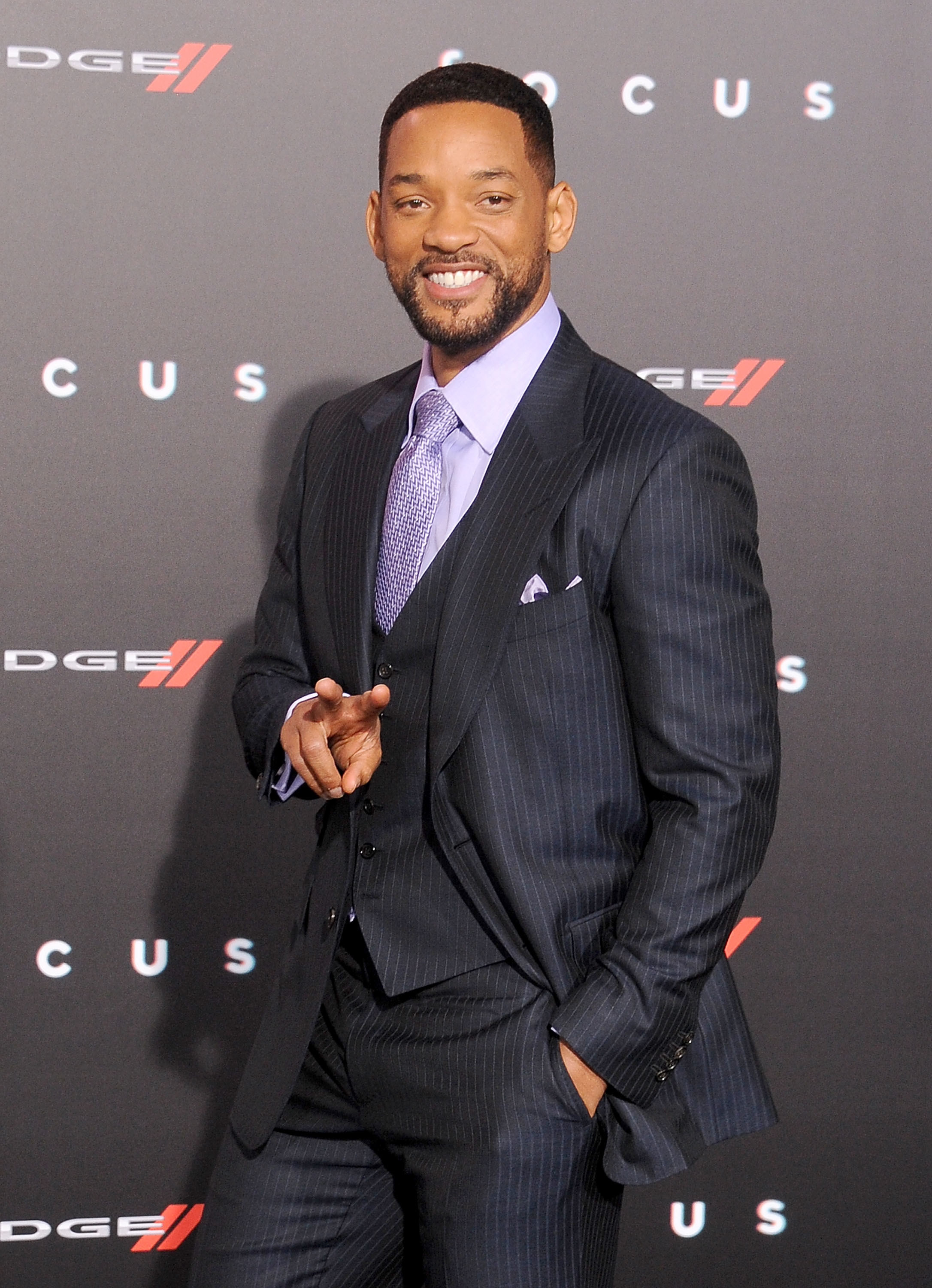 Will Smith smiles and gives the peace sign