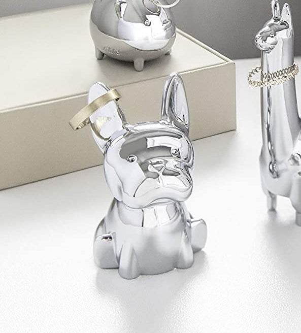 A french bulldog ring holder with a ring on it