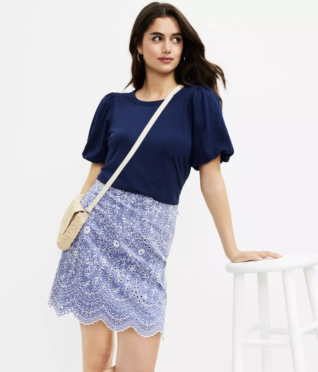 Model wearing the blue scalloped mini skirt with blue blouse