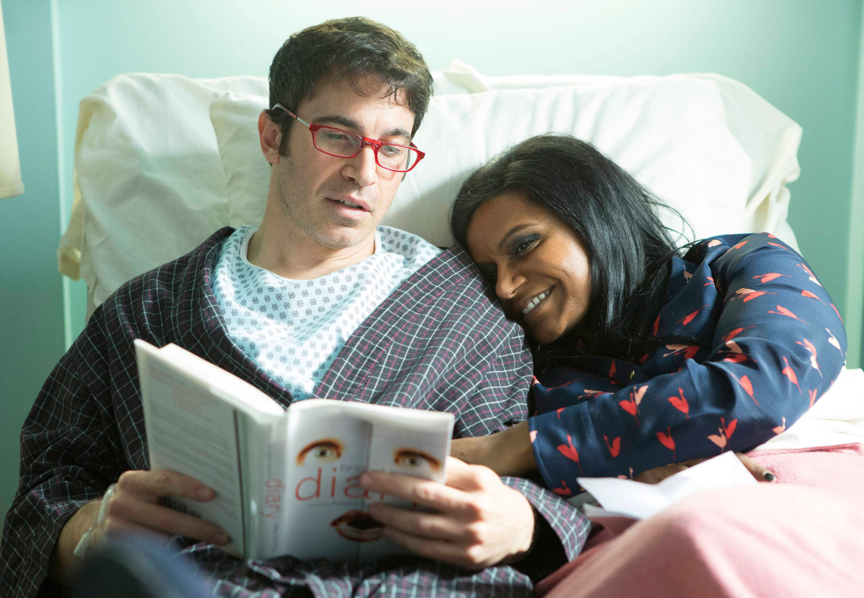 a character reading with glasses on while another character cuddles up beside him