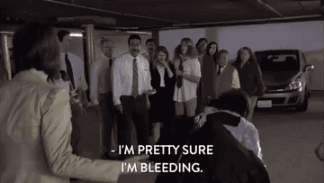 Crowd around an injured man in &quot;Workaholics&quot;