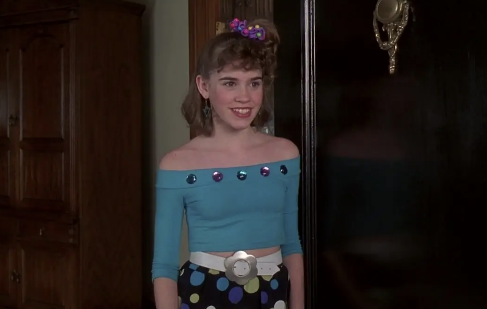 Christa wearing an off the shoulder &#x27;80s outfit with hair in a side pony