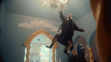 Anderson Paak hanging from a chandelier in his music video &quot;Bubblin&quot;