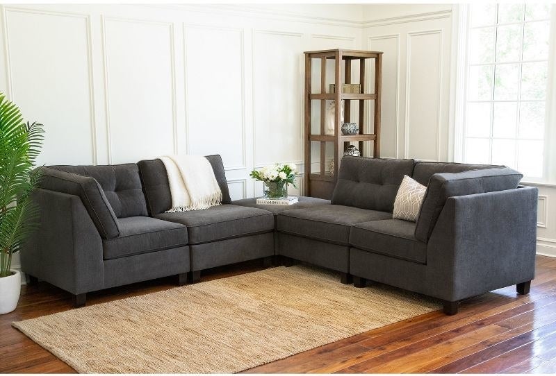 the grey sofa with the ottoman as the corner piece