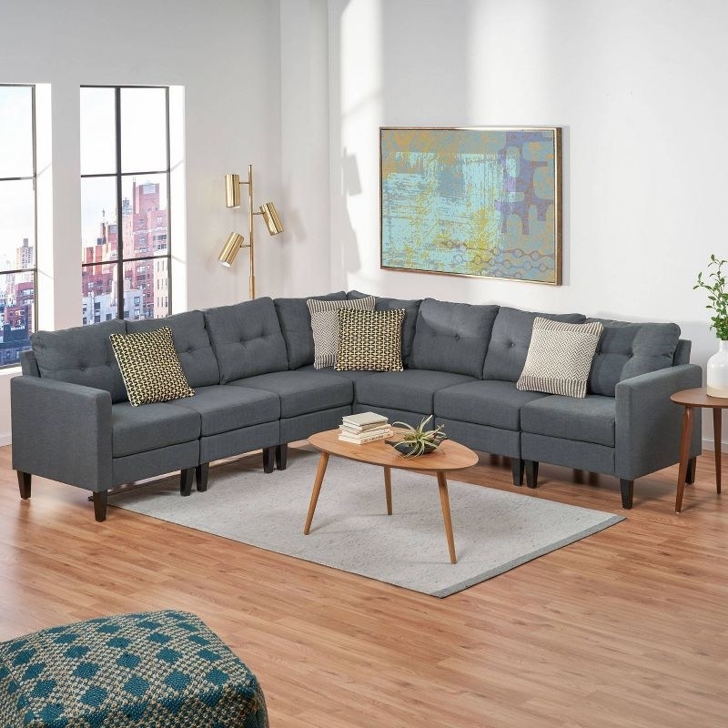 the large grey couch in a decorated living room