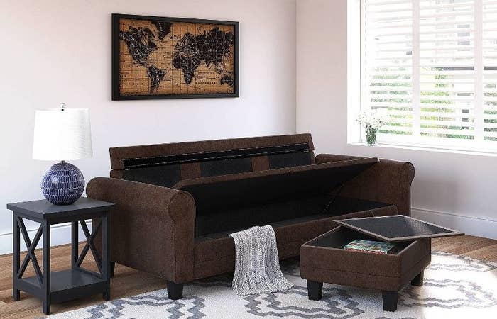 the brown sofa and ottoman both open to show the storage compartments