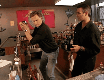 GIF of Conan O&#x27;Brien shaking a drink on the show &quot;Late Night with Conan O&#x27;Brien&quot;