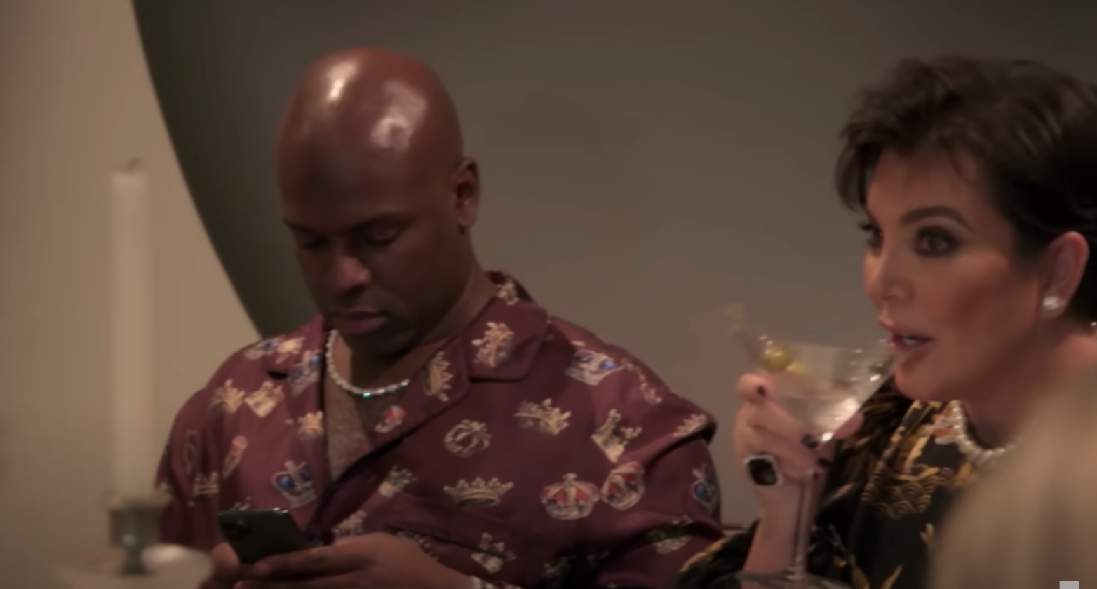 Kris drinking a martini and Corey on his phone