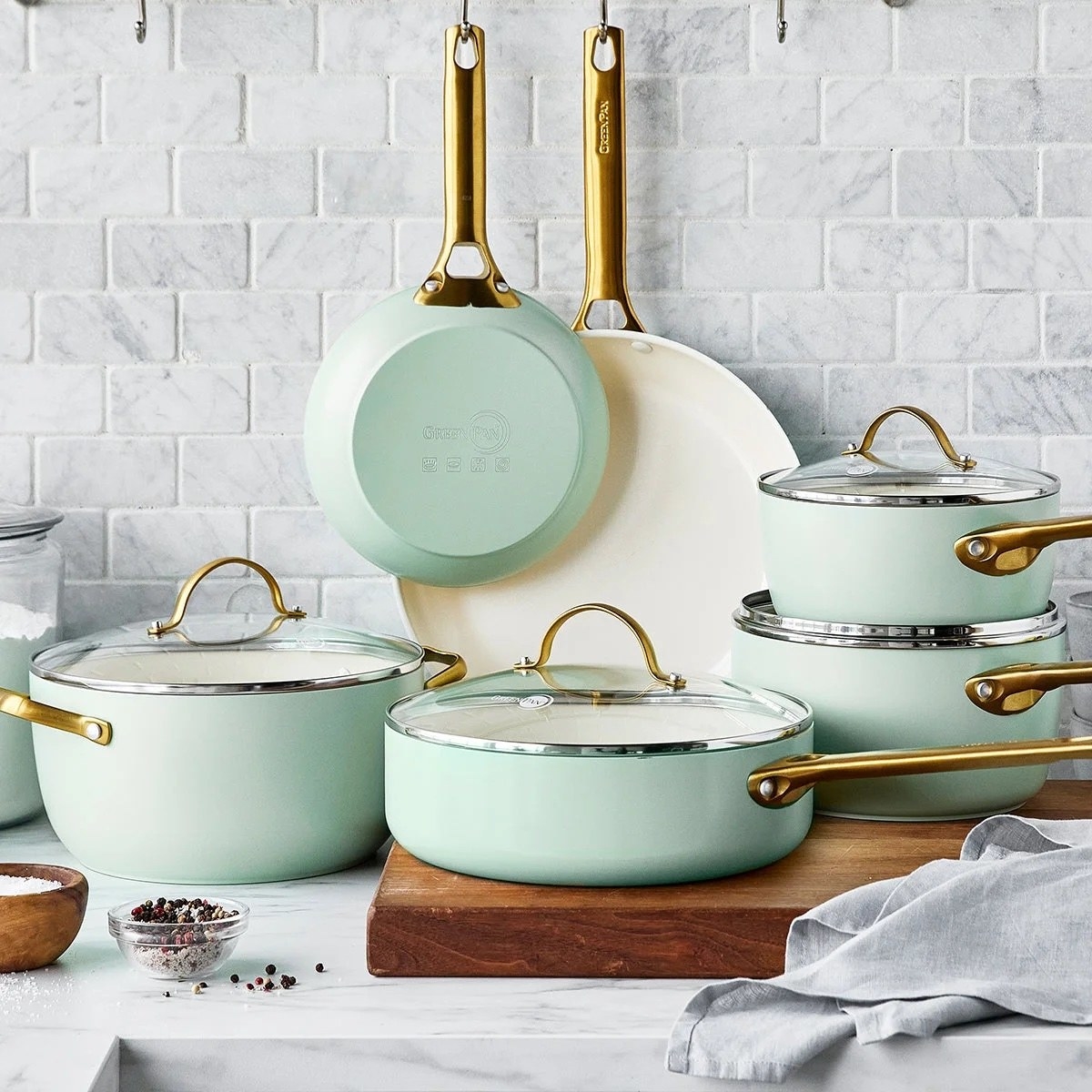 a set of ceramic pots and pans in mint green