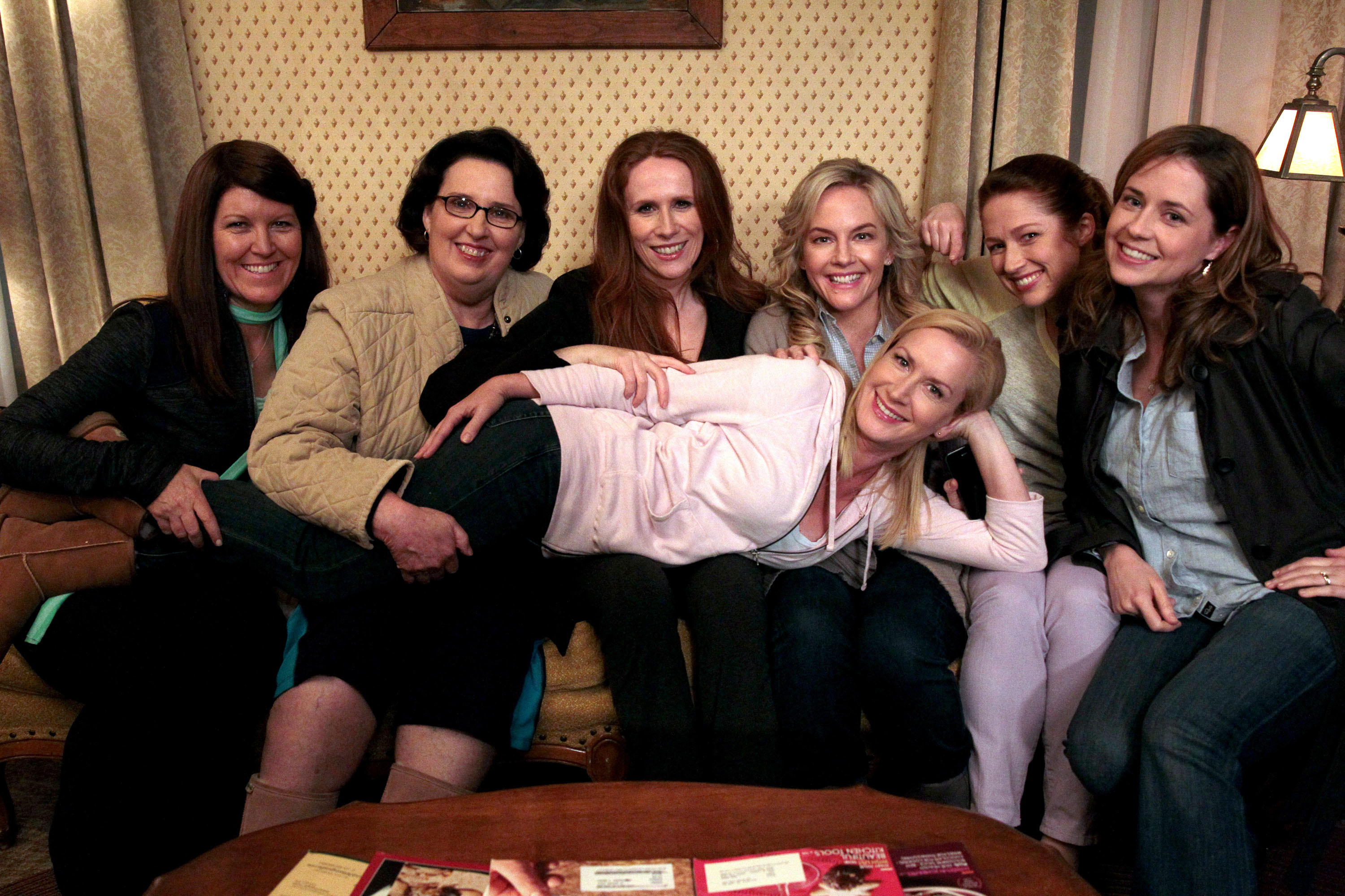 the women of the cast posing on a couch