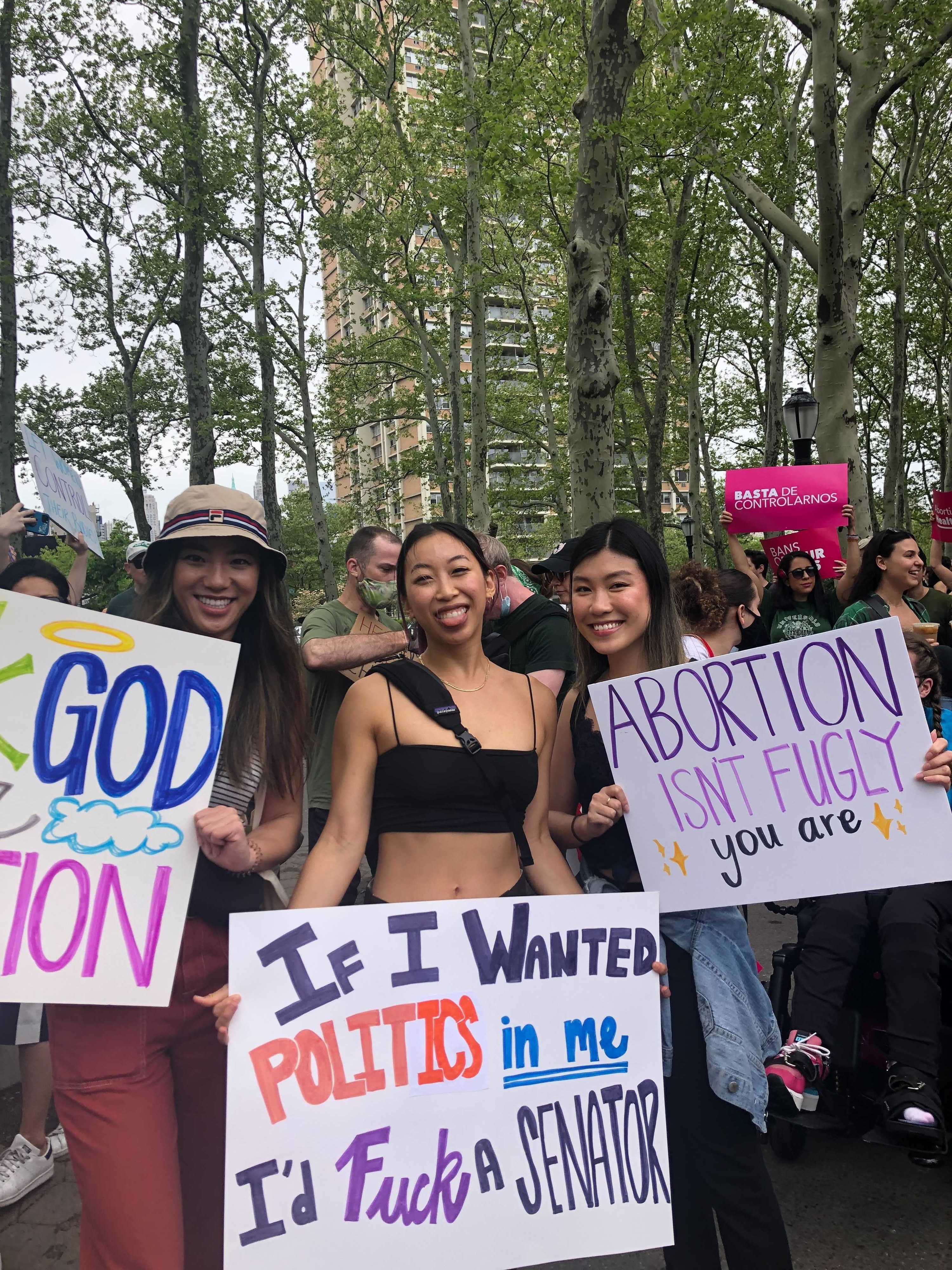 Signs reading &quot;If I wanted politics in me, I&#x27;d fuck a senator&quot; and &quot;Abortion isn&#x27;t fugly, you are&quot;
