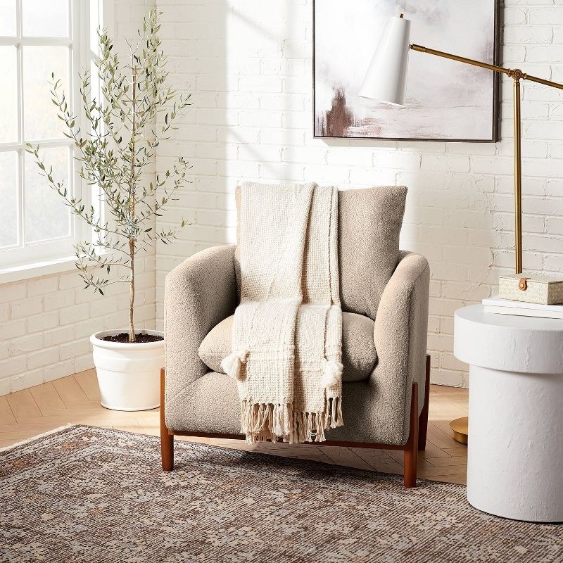 The chair in tan boucle in a sitting area
