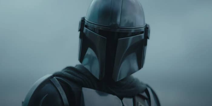 The Mandalorian wearing his armour and looking down